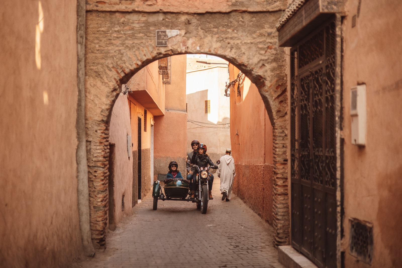 Side-car riding under an arch of the Marrakech medina