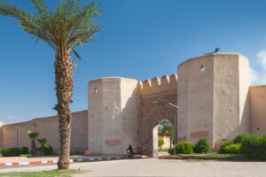 Bab Debagh gate and ochre ramparts of the Marrakech medina in the sunshine