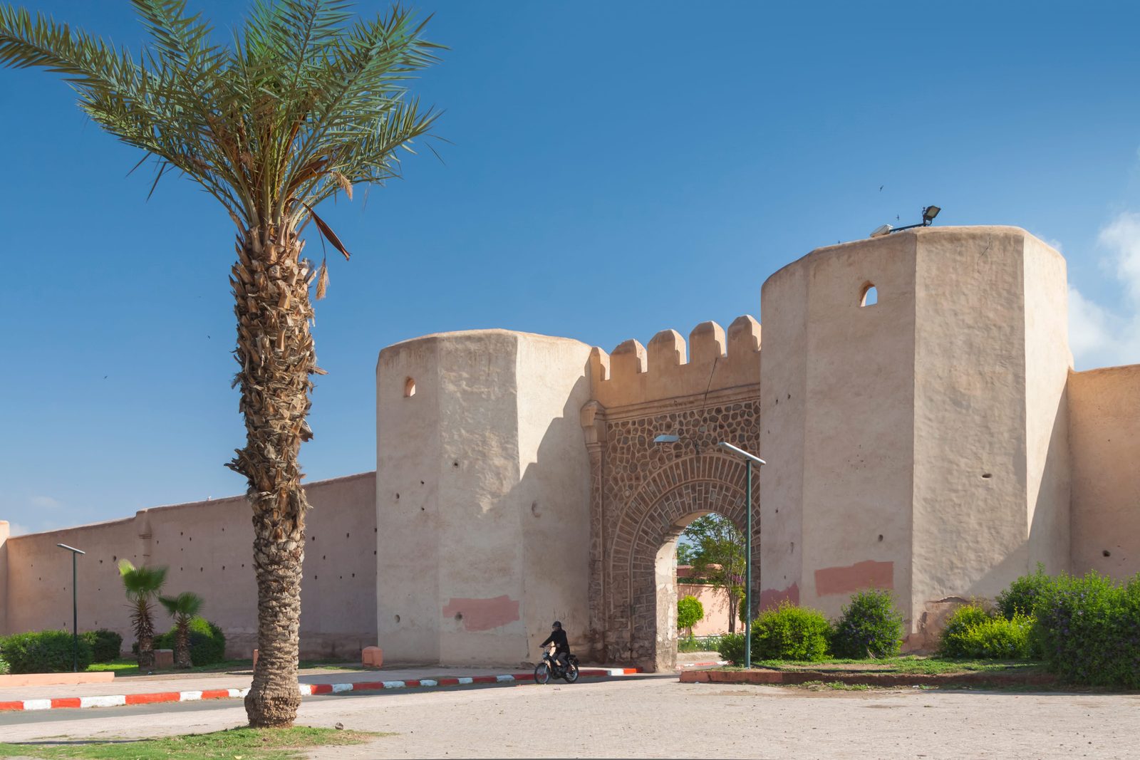 Bab Debagh gate and ochre ramparts of the Marrakech medina in the sunshine