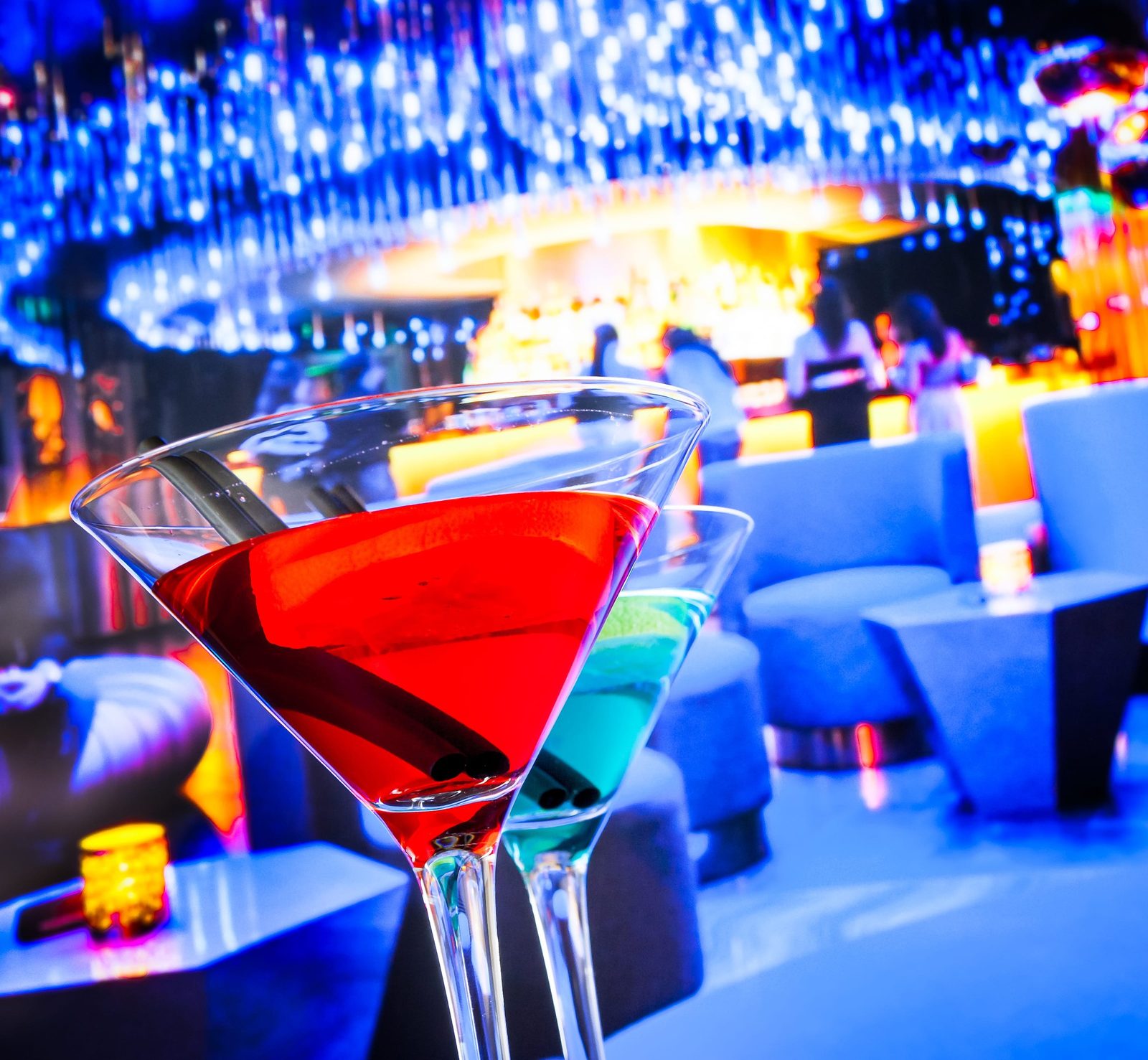 Colourful cocktails served in a lounge bar with a festive, dimly lit atmosphere