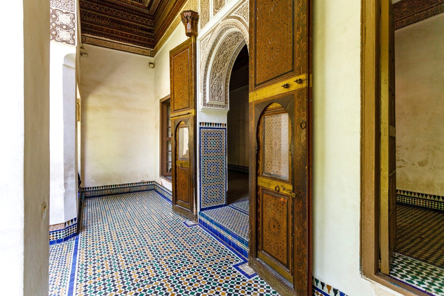 Flower-filled patio and colourful mosaics of the Bahia Palace in Marrakech