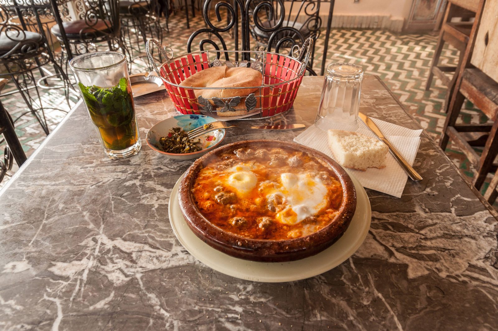 Moroccan restaurant table with traditional dishes in a warm setting